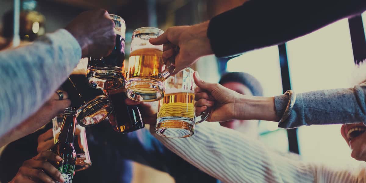 toasting with mugs of beer