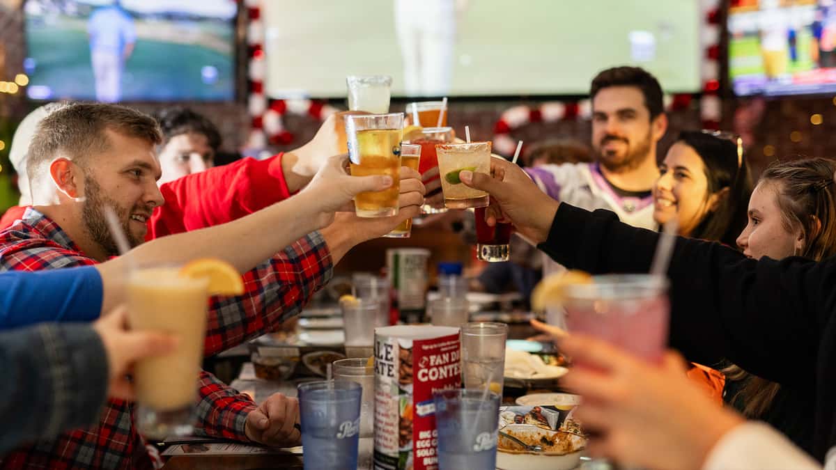A group of people with food and cocktails for a Corporate Event at Carolina Ale House