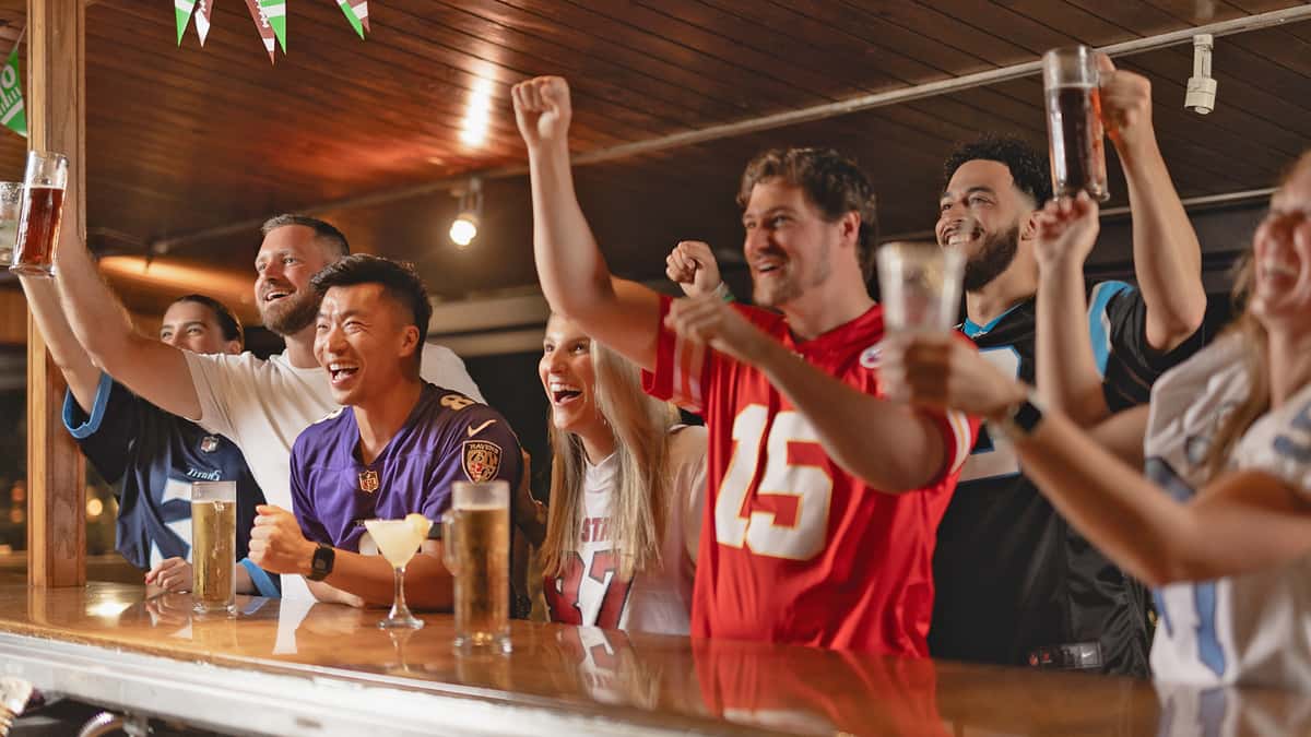Group of people cheering on their football team at Carolina Ale House