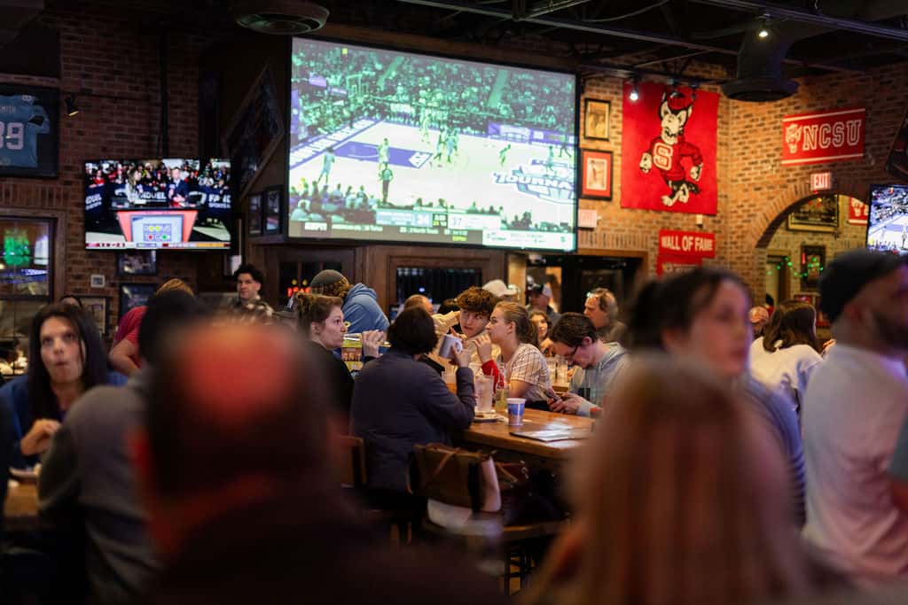 Projector screen showing UNC Duke at Carolina Ale House