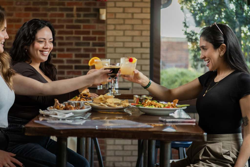 Women gathering for a reunion with food and cocktails at Carolina Ale House