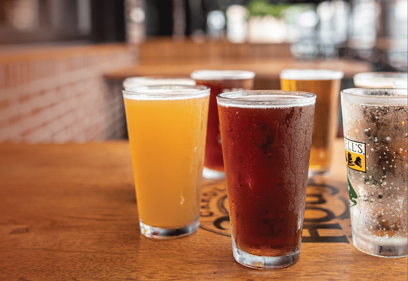 Different colored beers in glasses on a table