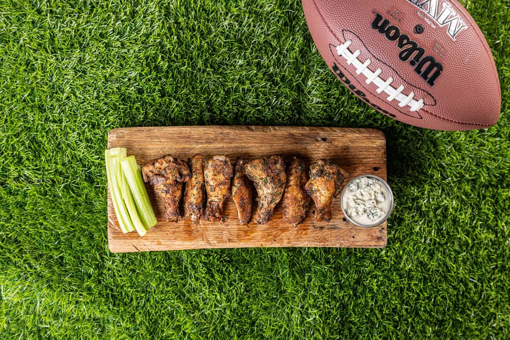 Chicken wings on wooden board with football at Carolina Ale House