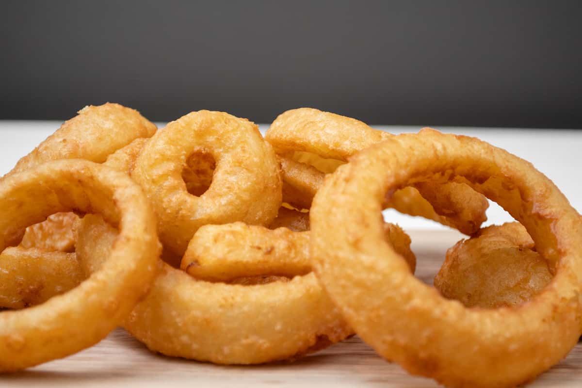 Close up of onion rings on a wooden tray