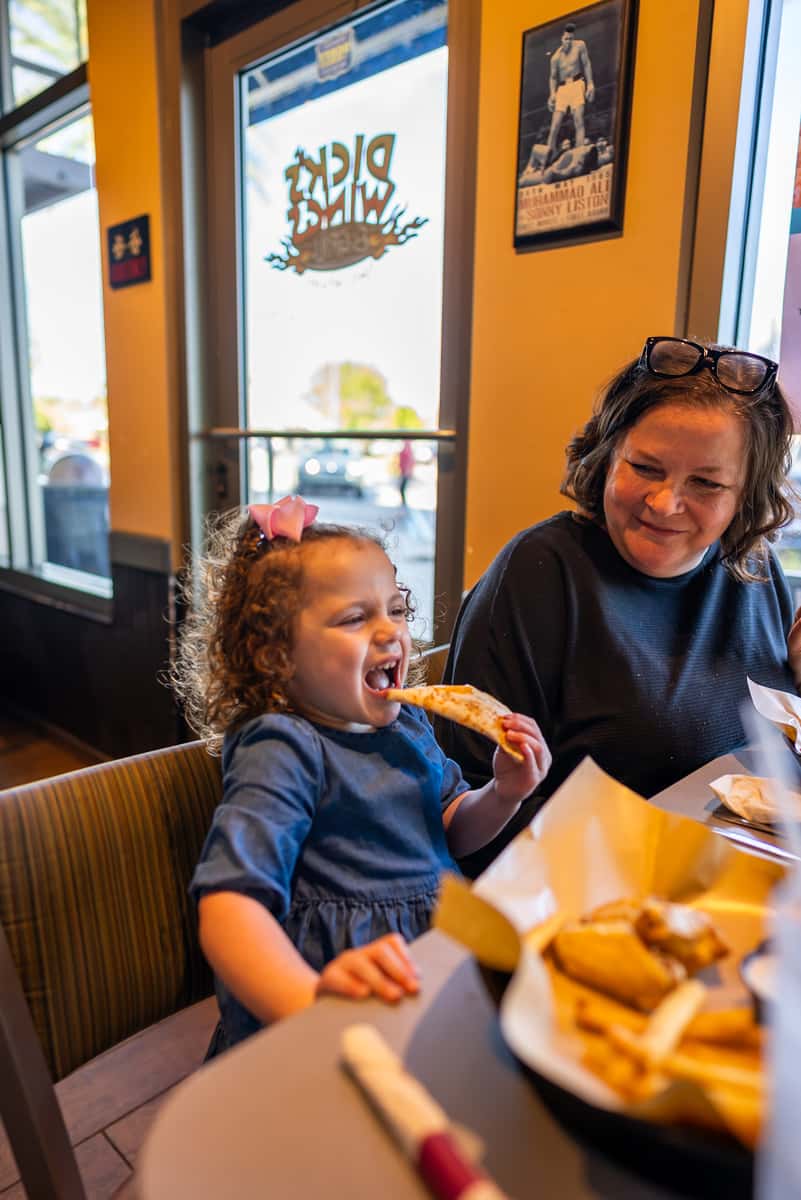 Grandma and child eating at Dick's Wings & Grill