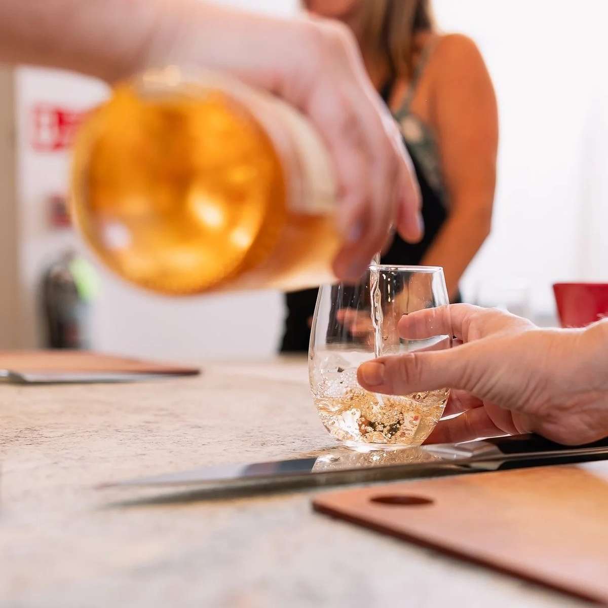 Wine being poured into tasting glasses during an upscale restaurant wine tasting and culinary event