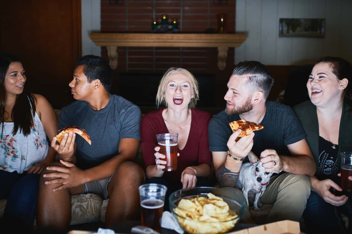 group of people eating pizza