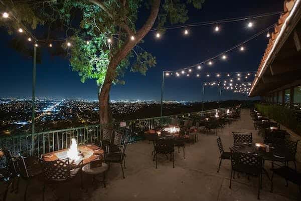 Night time patio dining with a skyline view of Orange, CA