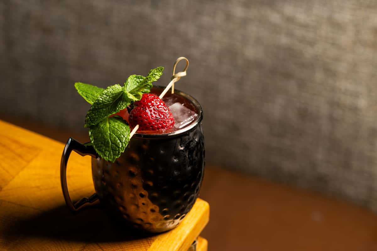 strawberry dreamin cocktail with a strawberry
