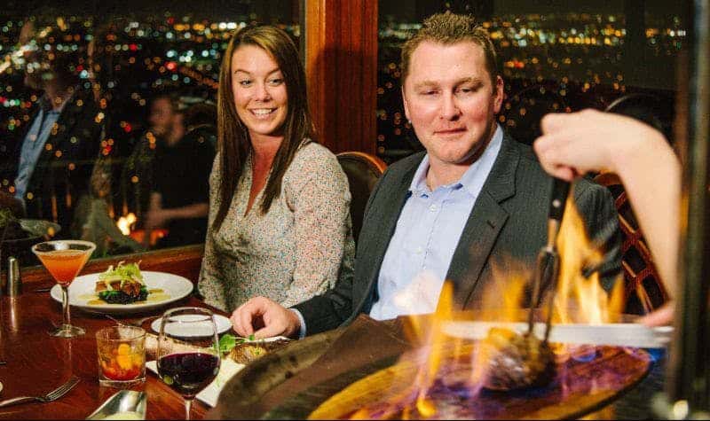 Couple enjoying the ambient experience of Orange Hill with fireside table service