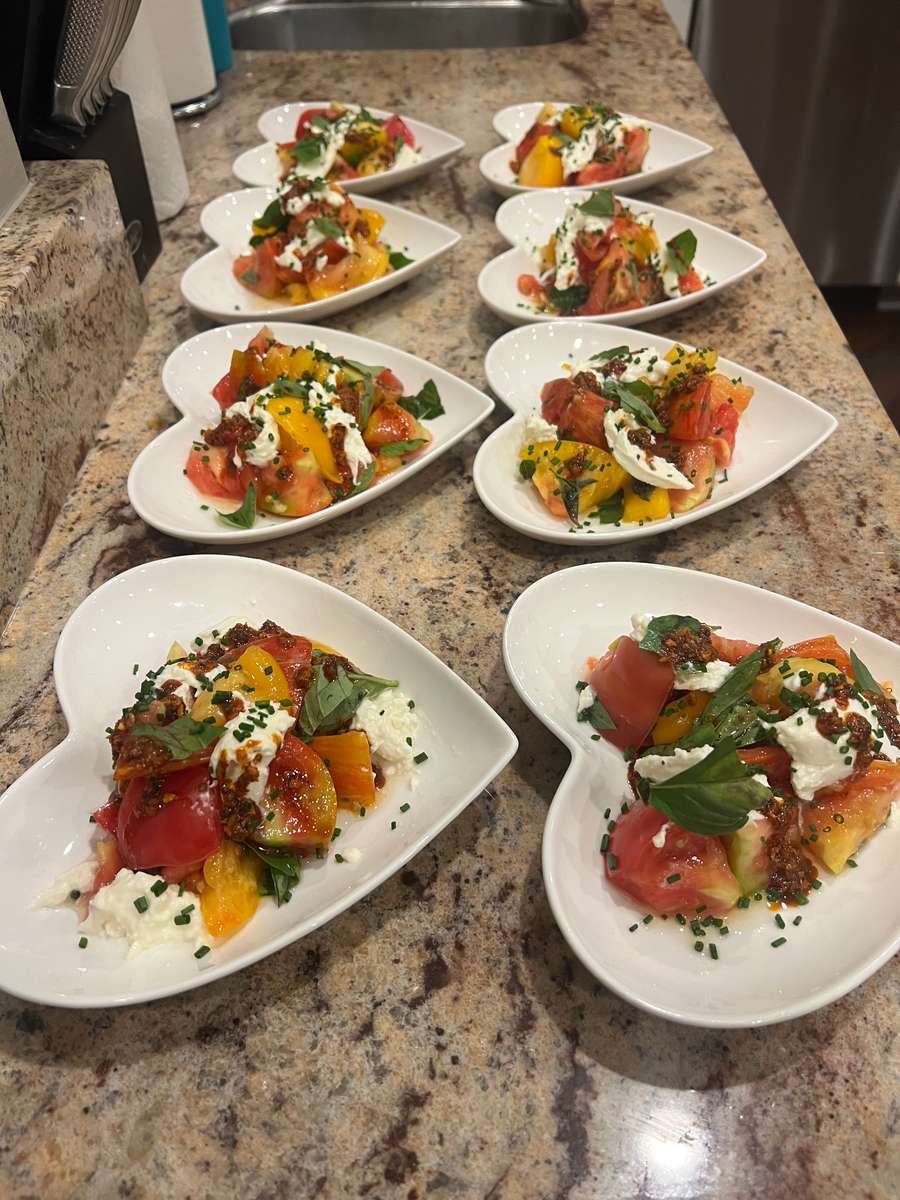 caprese salad with heirloom tomatoes, thai basil, chili crisp