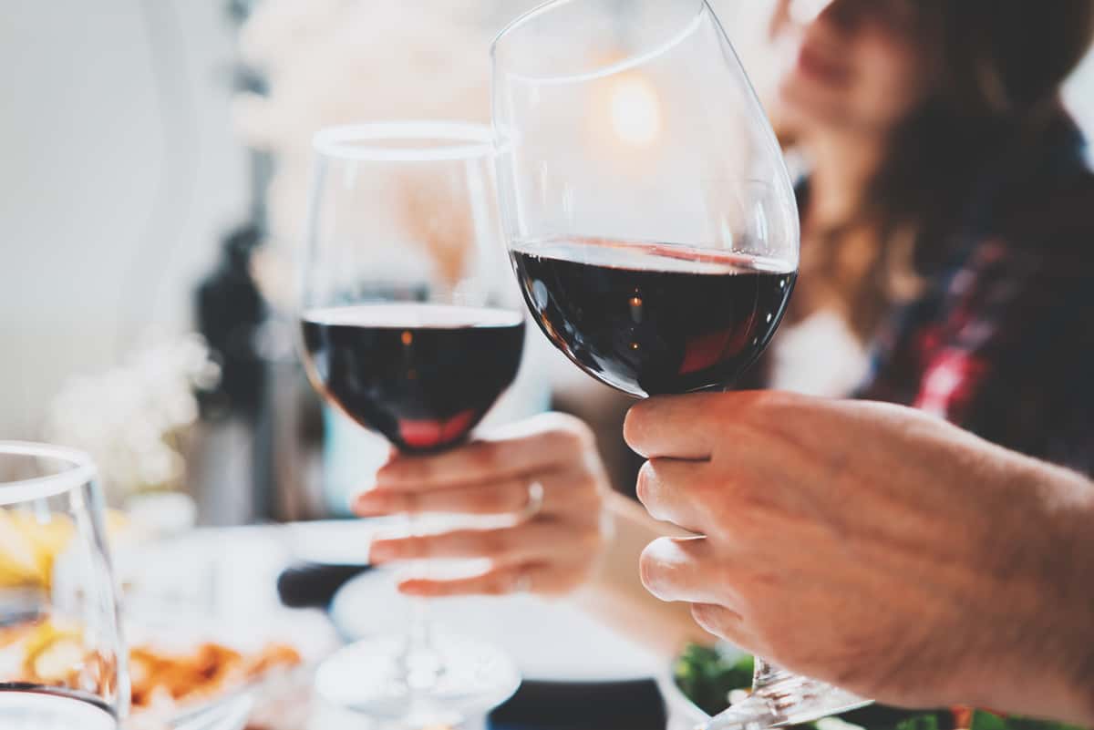 toasting with glasses of red wine