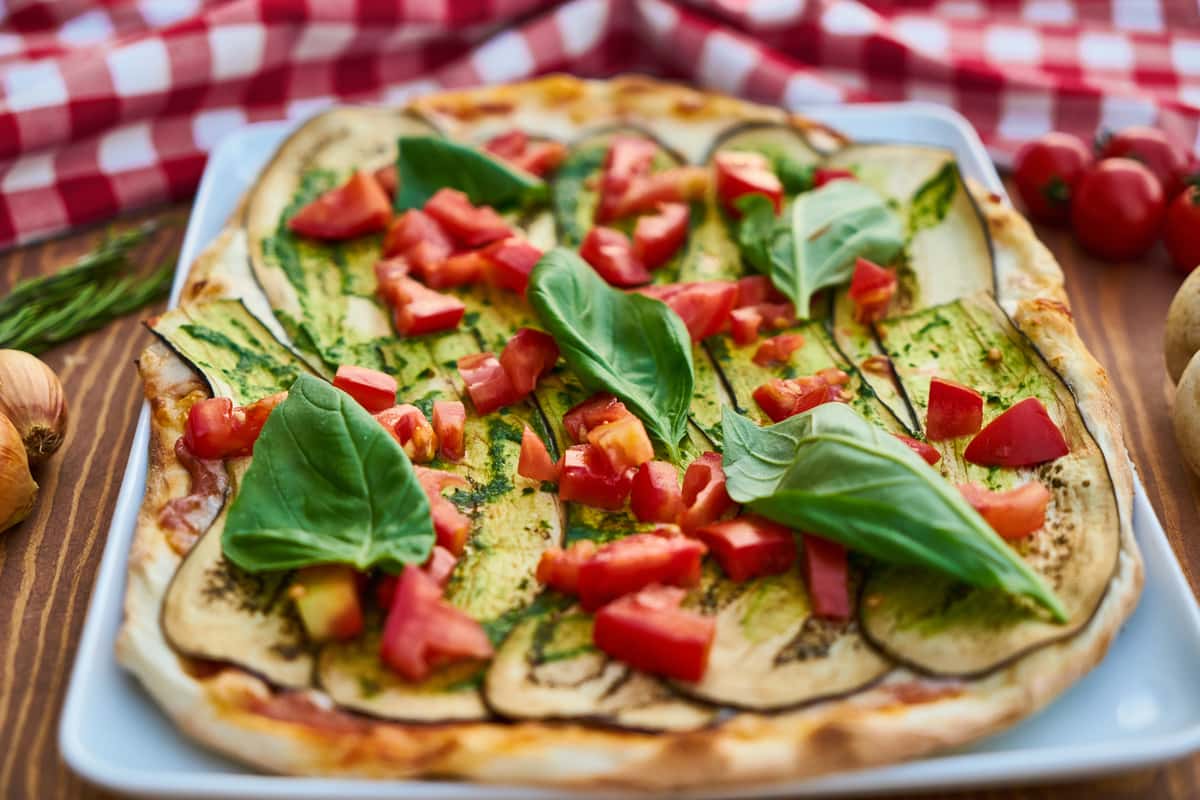 square pizza with tomatoes, eggplant and basil