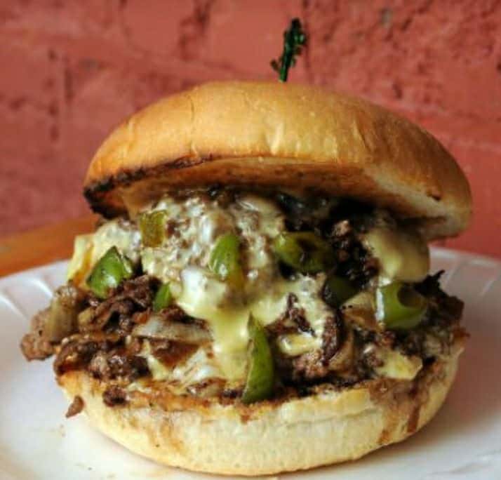 Philly Cheese burger: Burger topped with sauteed peppers, onions and shredded beef. Topped with cheese sauce.