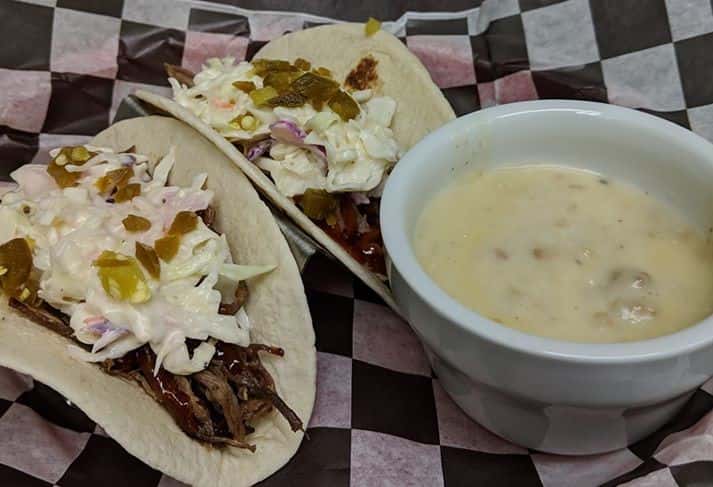 pulled pork tacos topped with coleslaw and jalapenos. Cup of soup on the side.