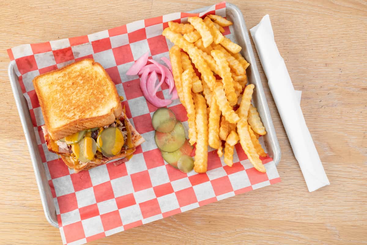 BBQ Cuban sandwich with smoked pork, pickles, melted cheese, and crinkle-cut fries at North Georgia BBQ