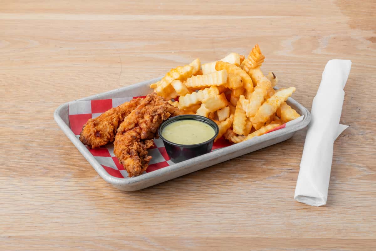 Kid's chicken fingers served with crinkle-cut french fries and dipping sauce in a metal tray at North Georgia BBQ restaurant