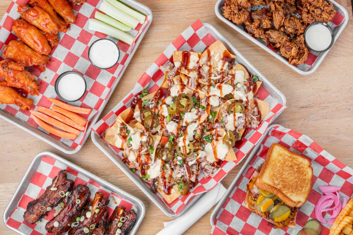 Signature North Georgia BBQ spread featuring barbecue nachos, smoked ribs, wings, sandwiches, and Southern comfort food favorites
