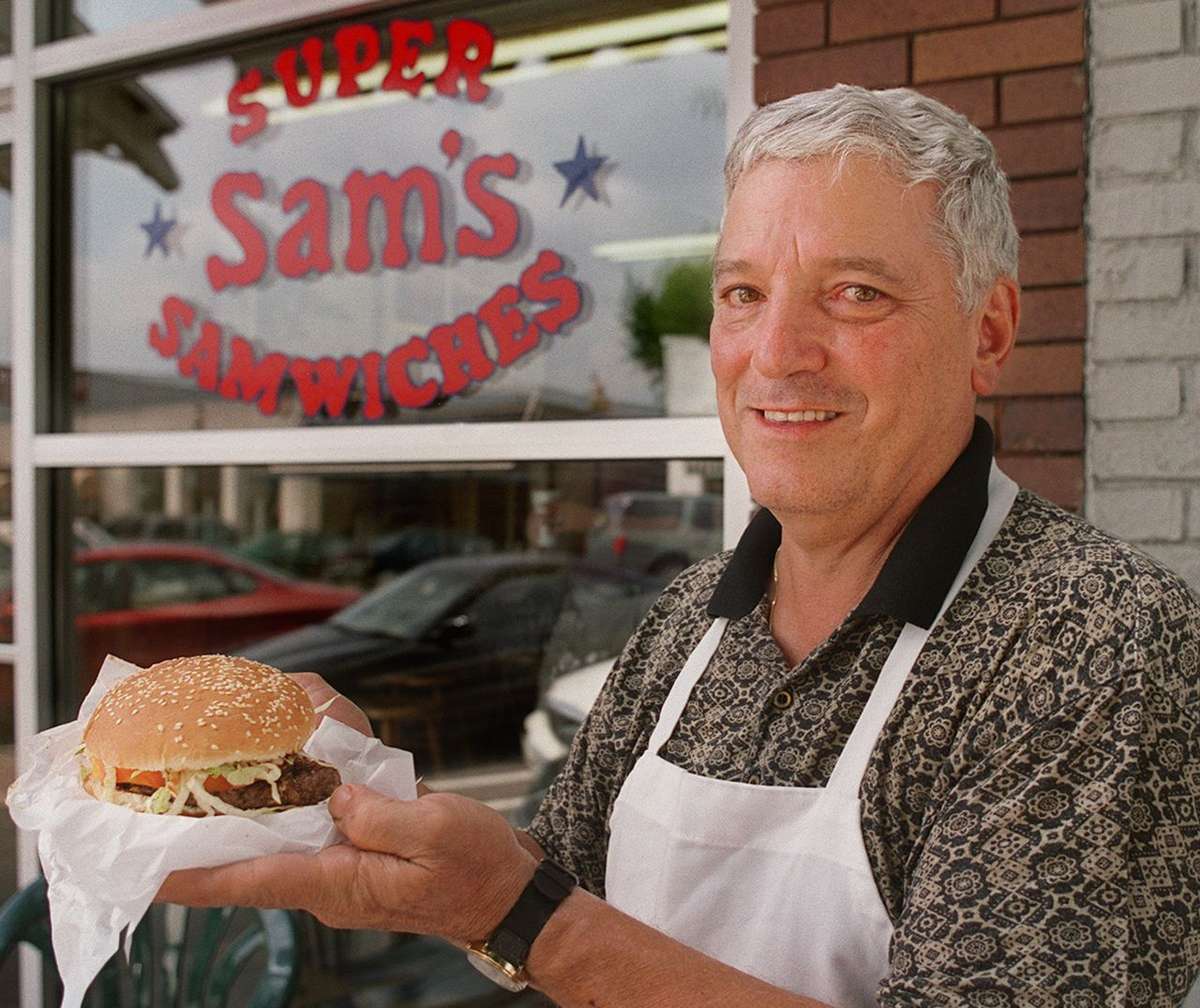 Employee holding burger
