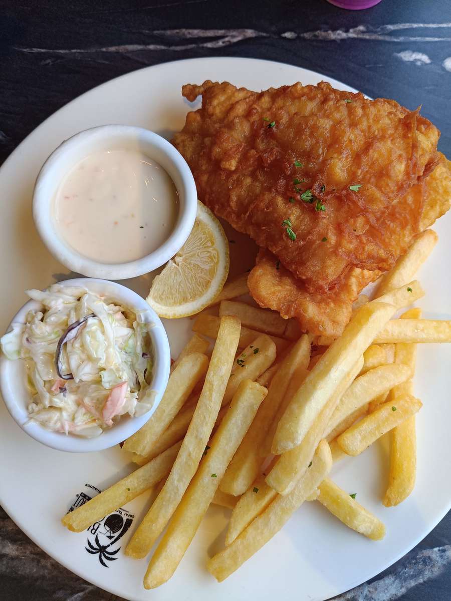Traditional battered fish and golden chips served with coleslaw, lemon and a creamy dipping sauce.