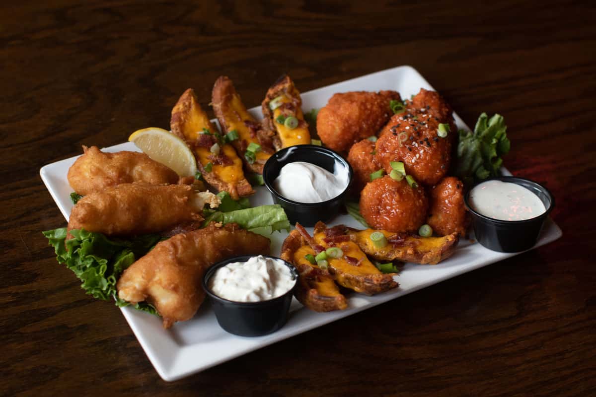 Baker Street Appetizer Trio with wings, twice baked potatoes, and fish