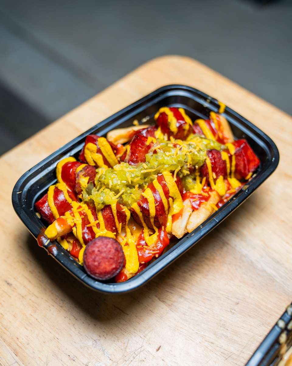Close-up of FryDay gourmet loaded fries topped with signature ingredients in Van Nuys