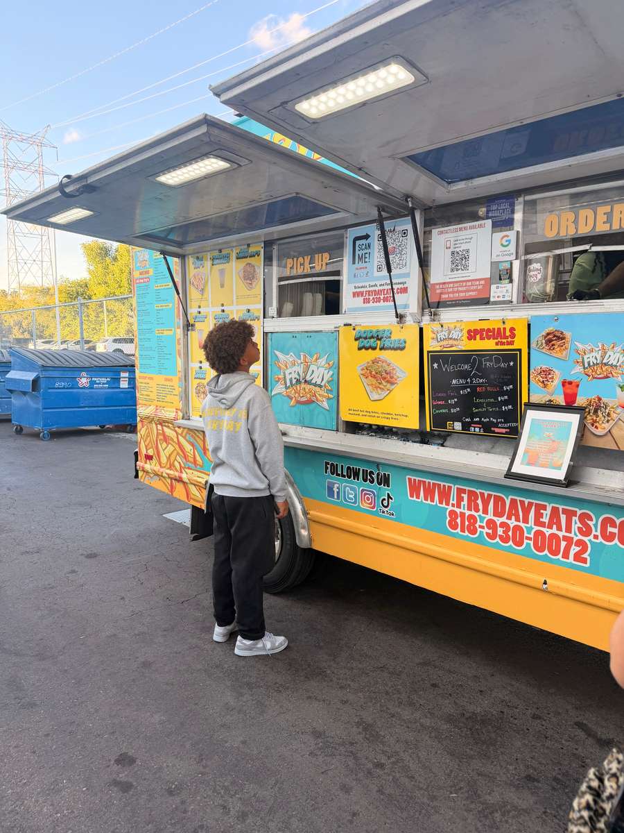 FryDay food truck franchise opportunity in Los Angeles - customer ordering loaded fries at the truck window