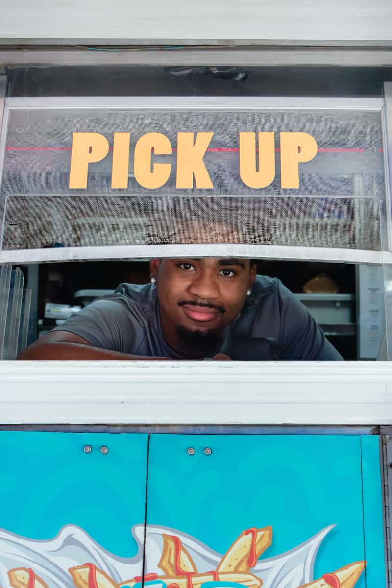 Guest at the FryDay Food Truck pickup window during a Los Angeles client appreciation event