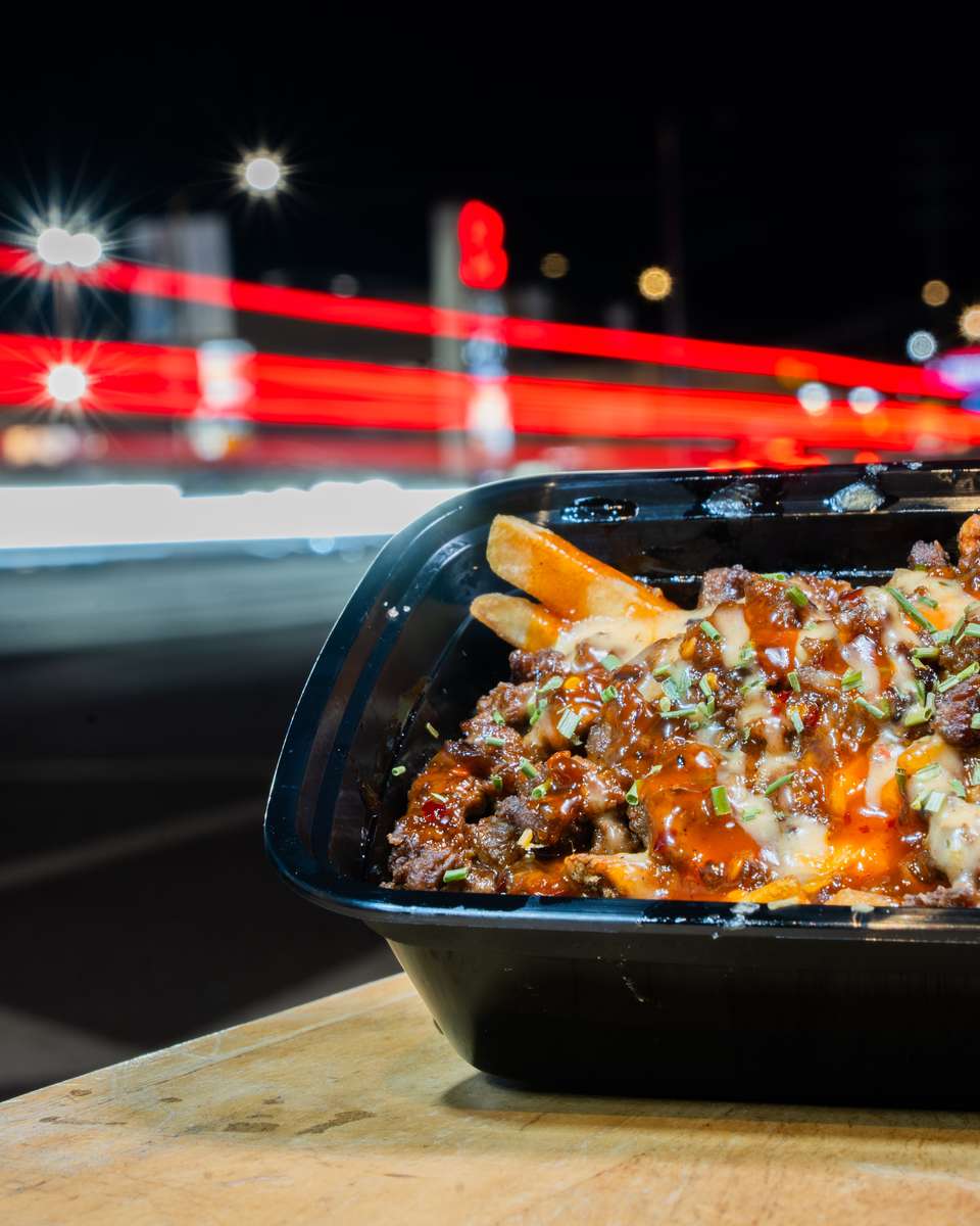 Close-up of FryDay gourmet loaded fries served at a graduation party in LA