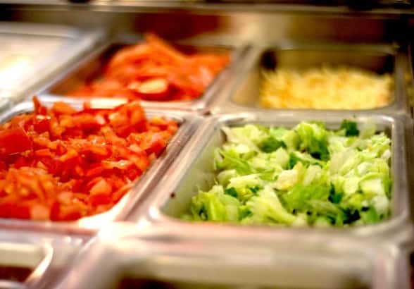 Food prep containers with lettuce, tomatoes, and cheese