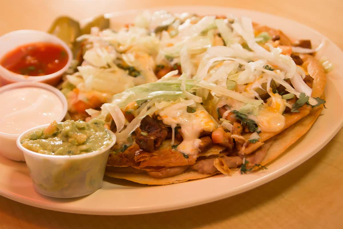 Chicken quesadilla topped with cheese, lettuce, jalapenos. Side of guacamole, salsa, ranch.