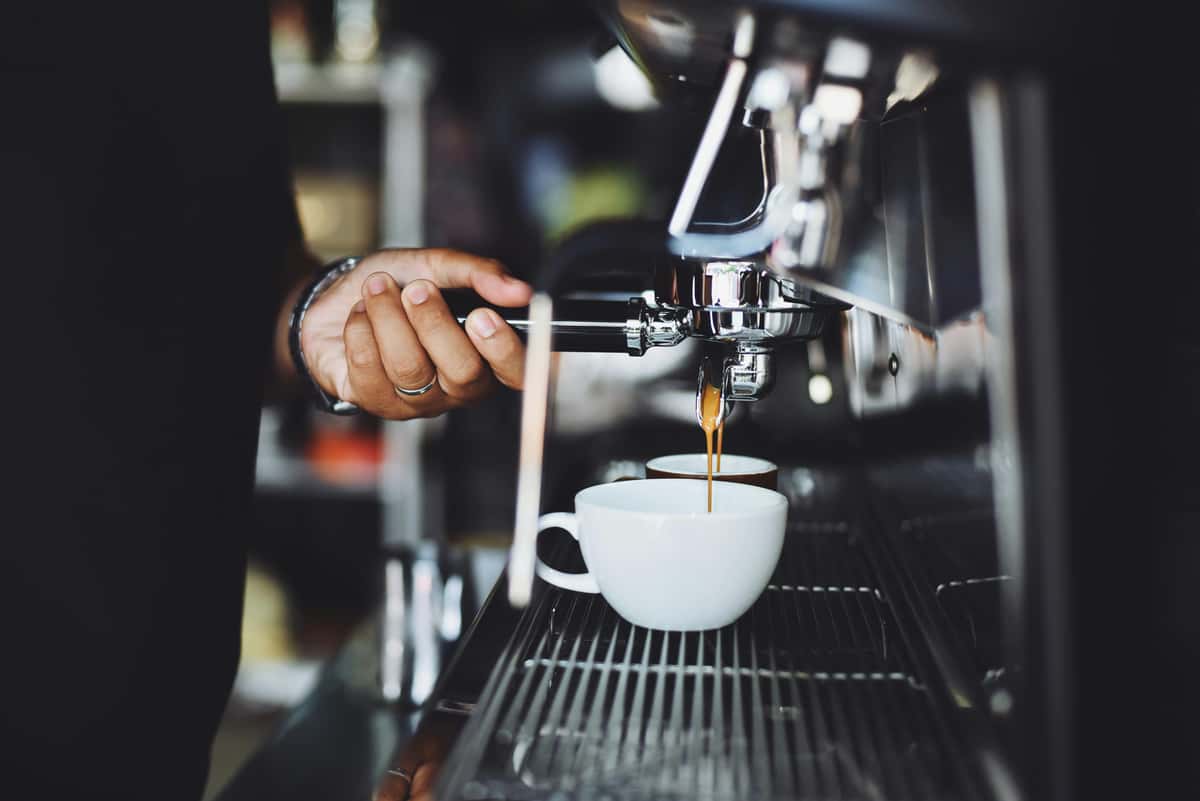 industrial coffee maker and a cup of coffee