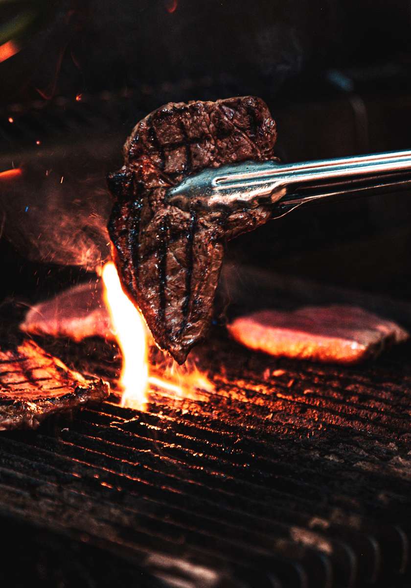 person grilling a steak