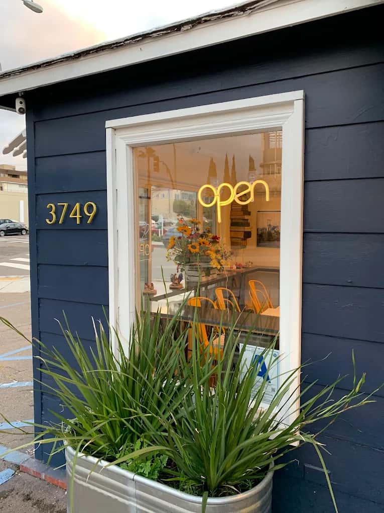 Exterior "open" sign of Sunnyboy Biscuit Co.