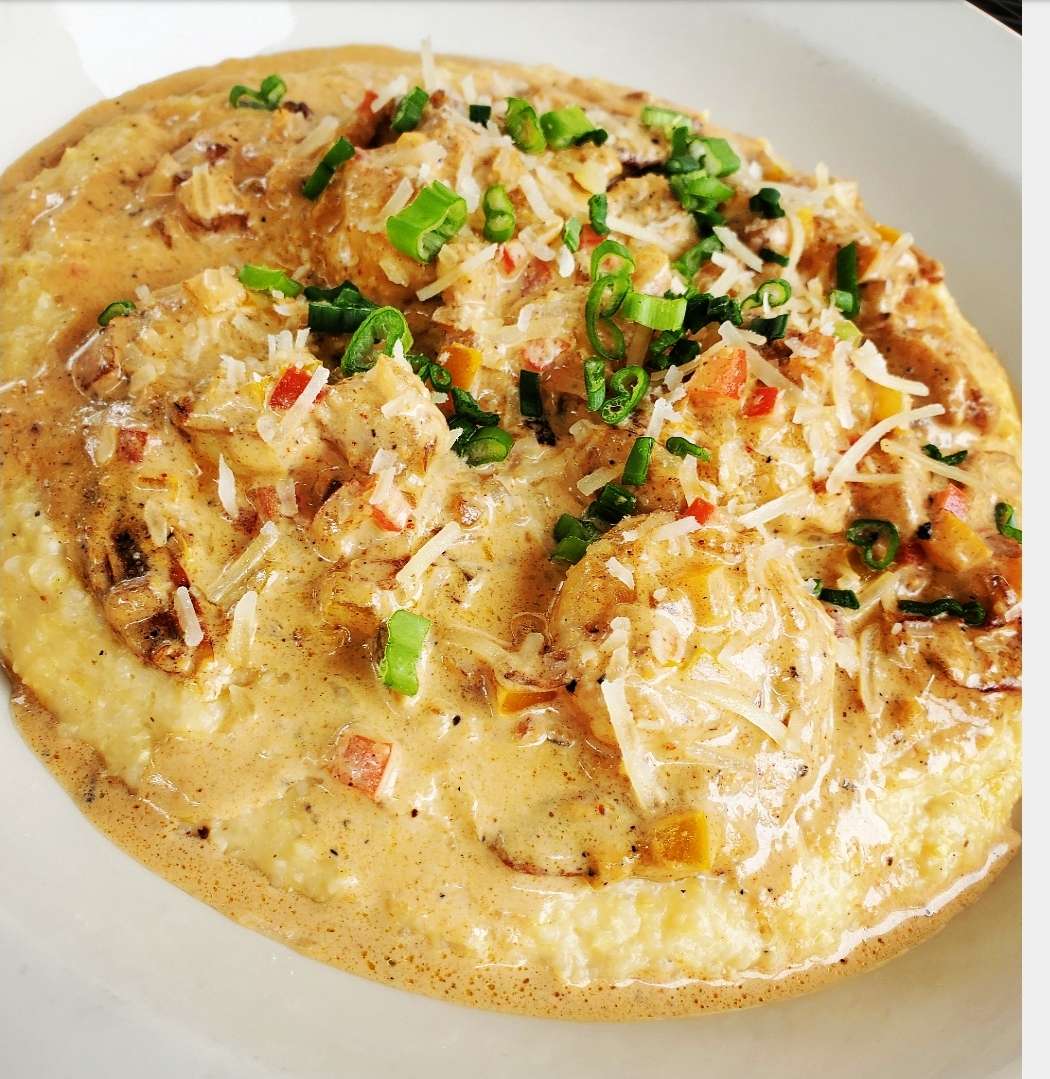 Cheddar Cheese Grits Topped W/ Sautéed Shrimp, Cajun Cream Sauce, Parmesan Cheese, & Parsley
