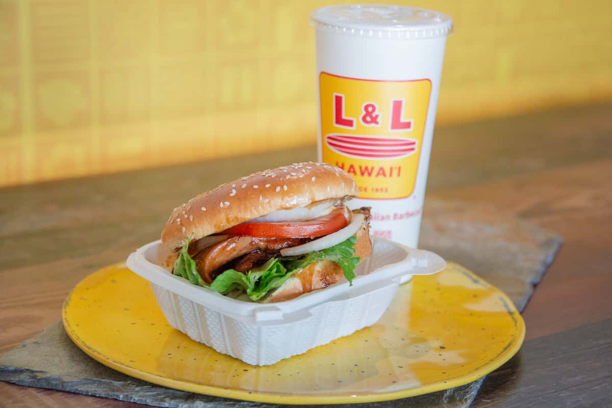 Hawaiian BBQ chicken sandwich with a drink