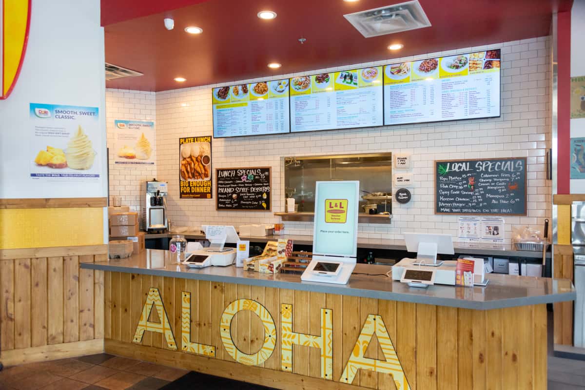 Front ordering counter with cash registers and digital menus at L&L Hawaiian Barbecue