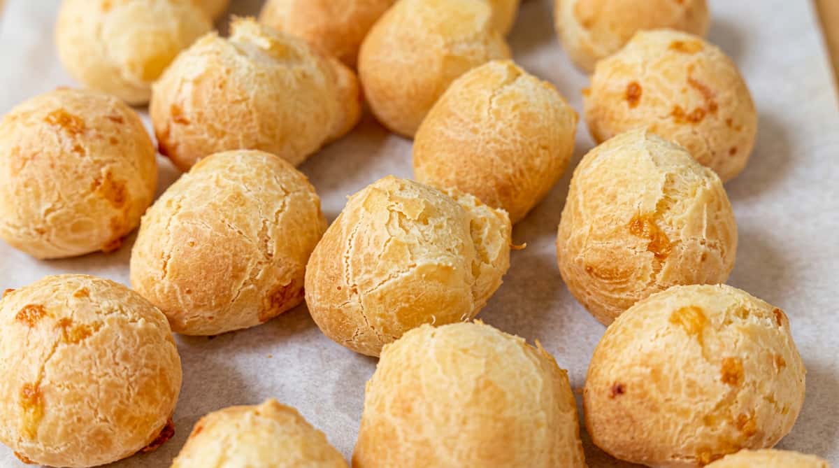 Authentic Brazilian cheese bread (pão de queijo) baked golden and fluffy, a traditional gluten-free favorite at Brazilian Family Bakery.
