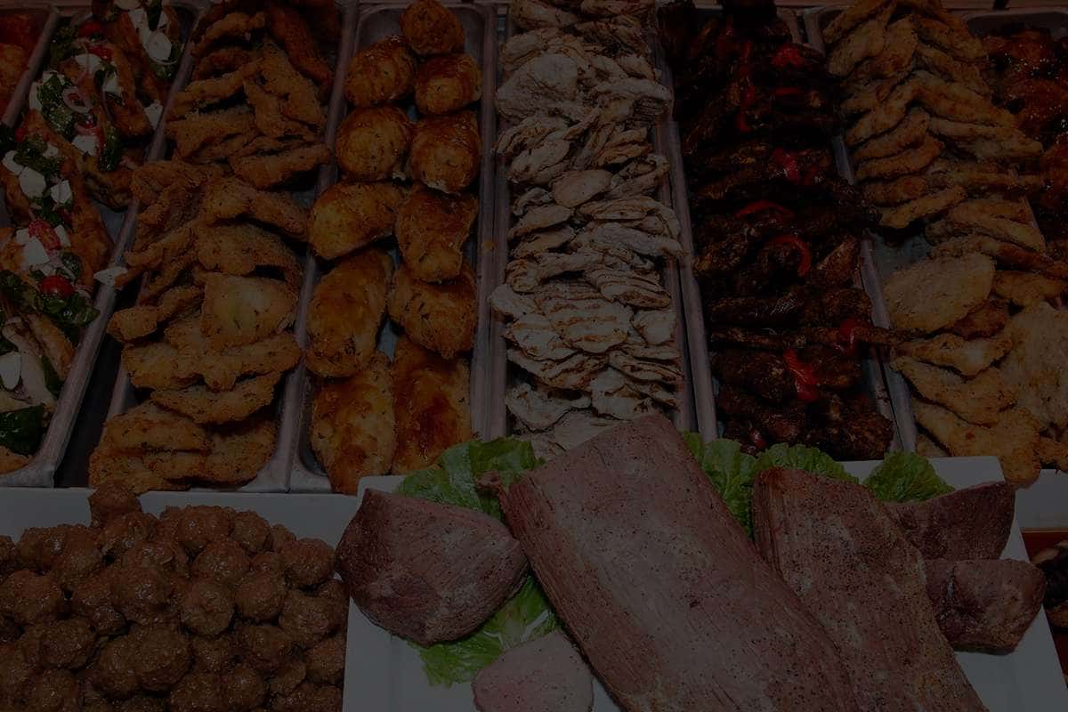 chicken cutlets, meatballs, grilled chicken, and other kinds of meat in a deli case