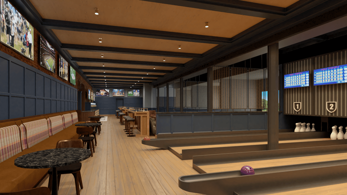 "Modern sports entertainment restaurant with indoor bowling lanes, booth seating, marble-top tables, and wall-mounted TVs creating an upscale game-day dining atmosphere.
