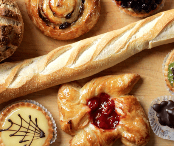 assortment of pastries with a loaf of bread