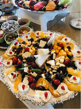 assortment of vegetables and cheese in a bowl with a side of olives on a tray