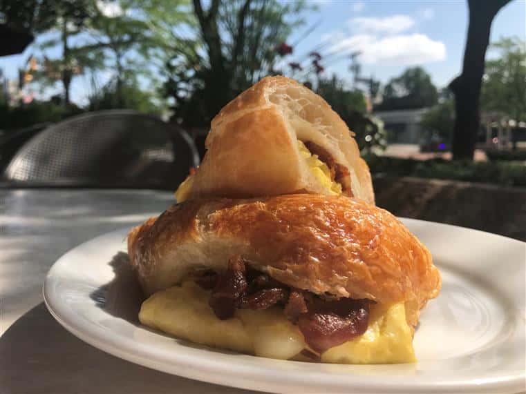 Croissant Egg sandwich with cheese and bacon on a plate
