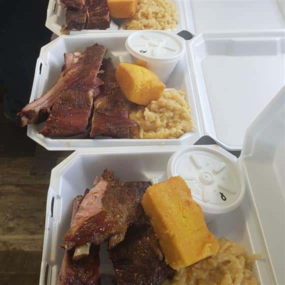 bbq ribs, mashed potatoes, and cornbread in to-go containers