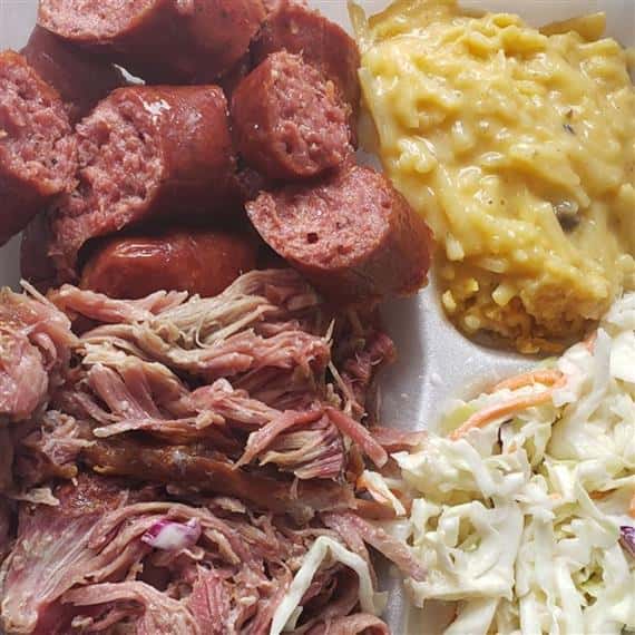 sliced and smoked meat with coleslaw and cream corn