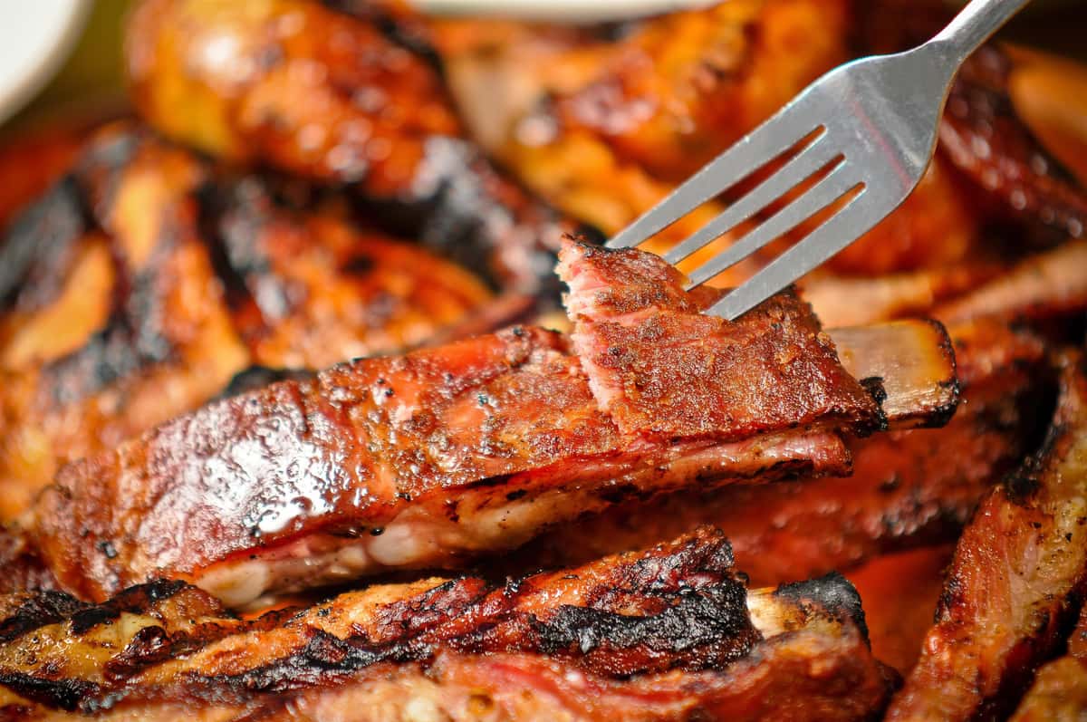 a fork with a piece of barbecue chicken