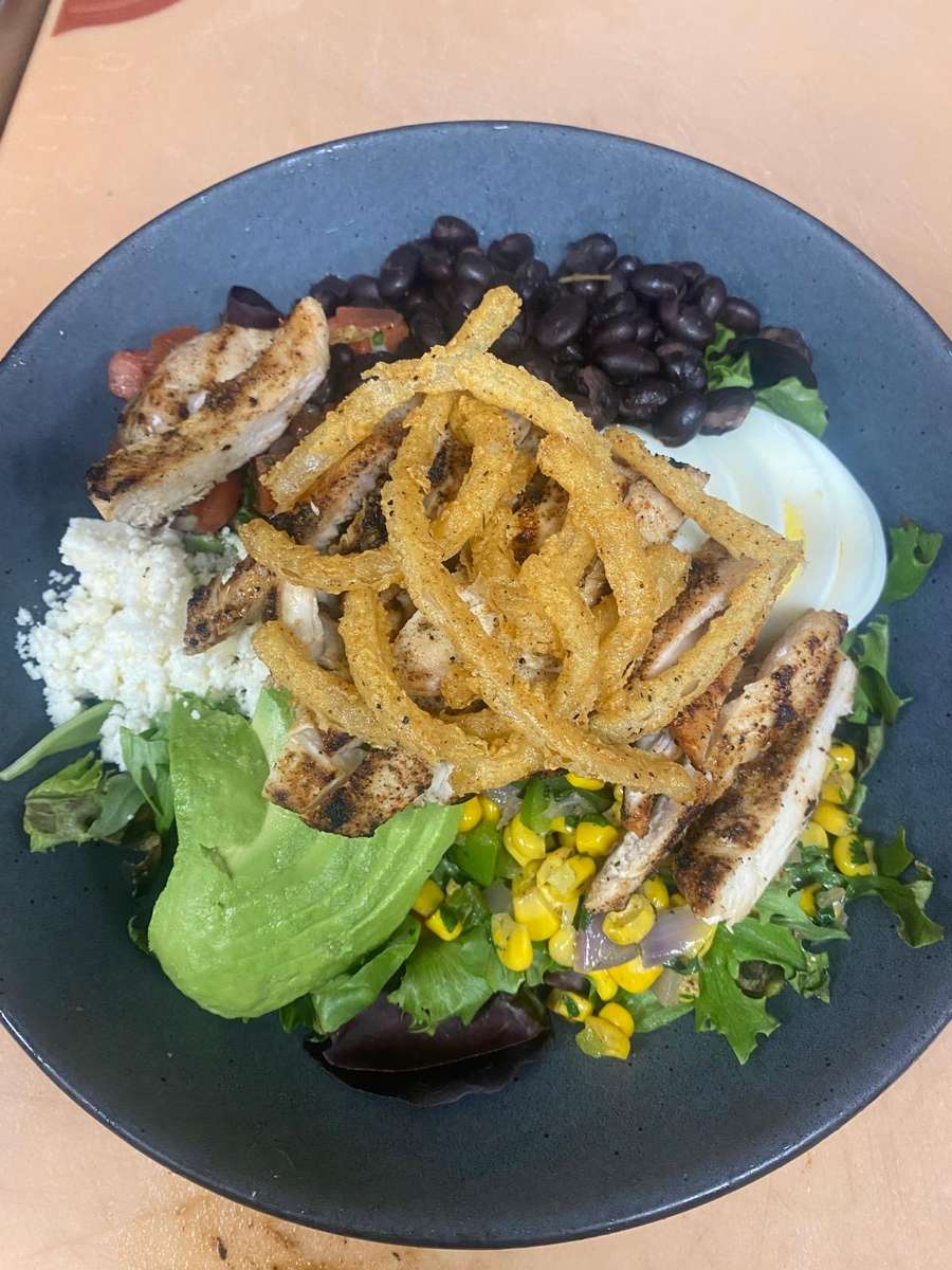 Salad with fried pieces on it