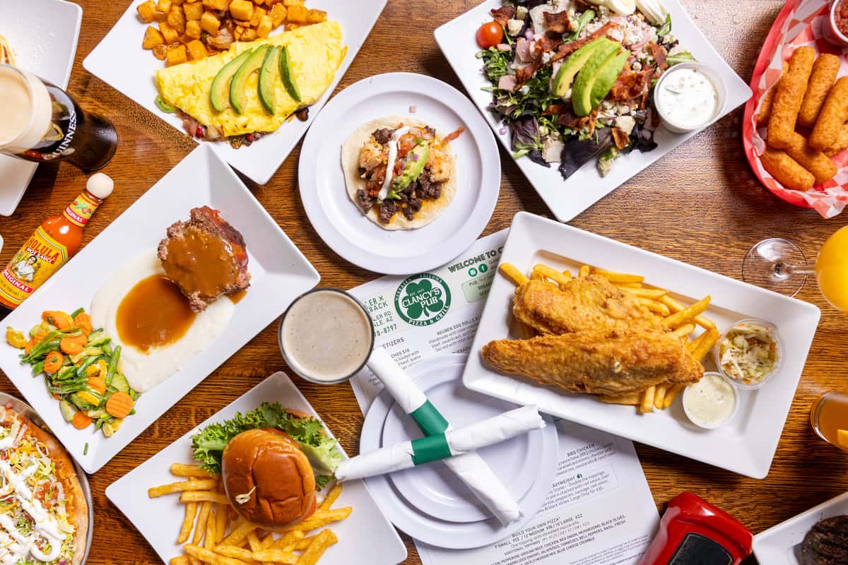 Overhead spread of burgers, breakfast favorites, salads, sandwiches, and pub classics from Clancy's menu.