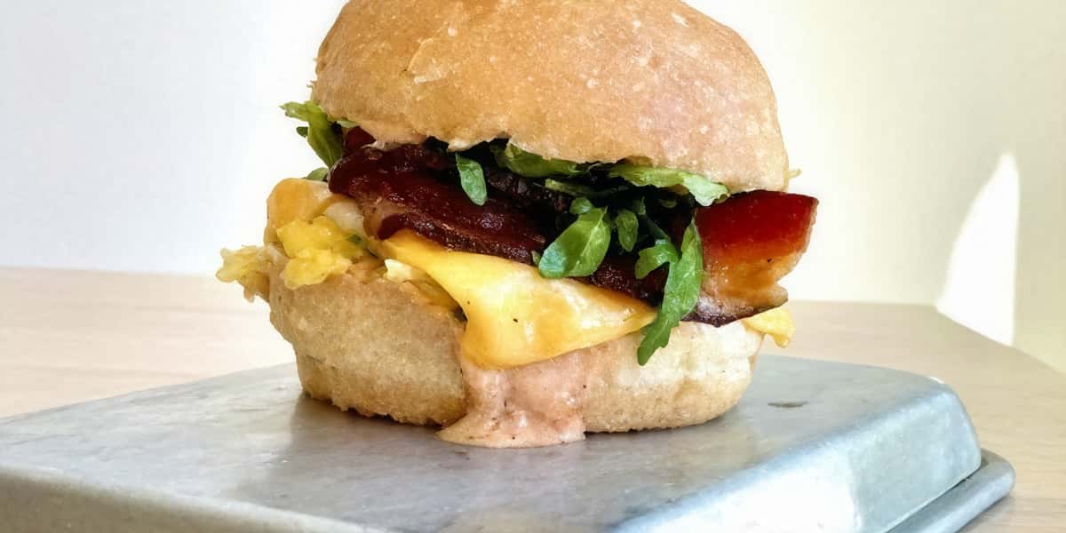 Egg sandwich with salad and bacon