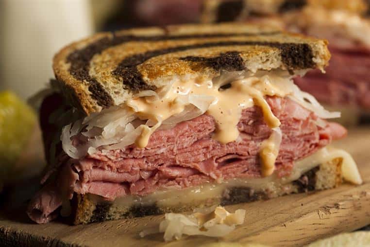 corned beef reuben with sauerkraut and spicy mayo on marble rye